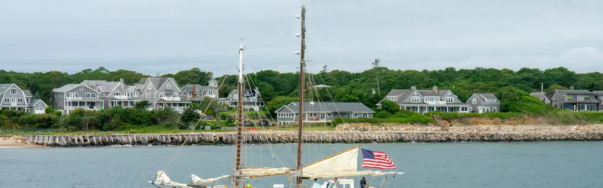 A sailboat floating in the middle of a body of water