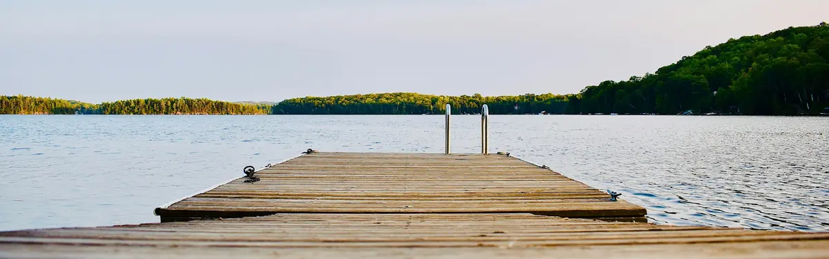 brown wooden dock on calm body ofwater